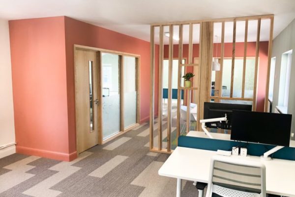 An office with natural light promoted with room dividers allowing light to pass through