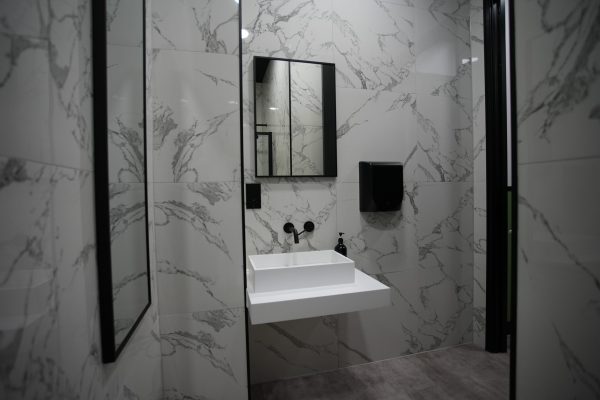 Lusso sink in marble tiled shower room