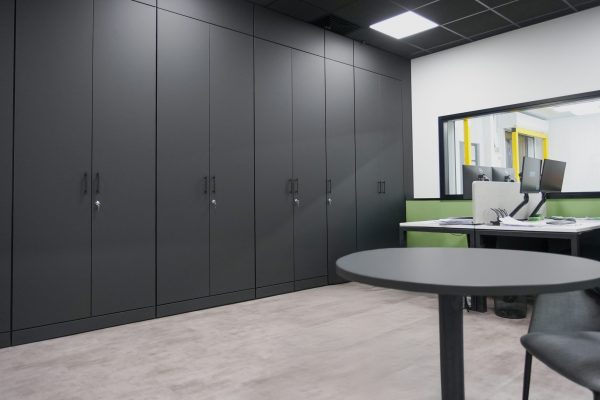 Matt black storage wall in office space